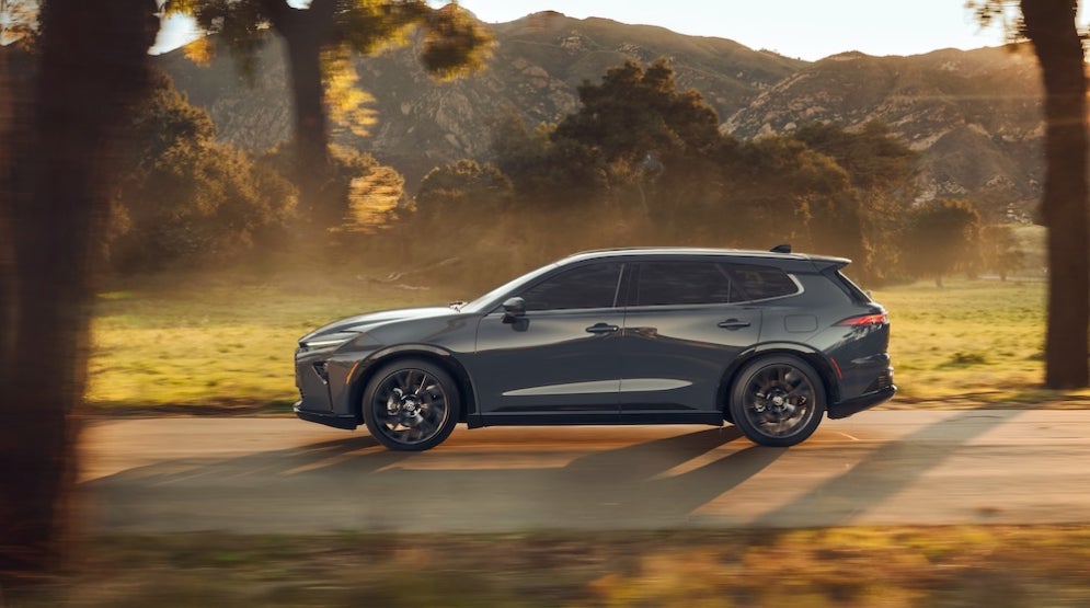 A gray Toyota Venza SUV driving down a rural road